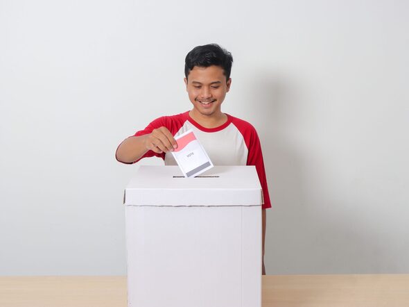 Portrait,Of,Excited,Asian,Man,Inserting,And,Putting,The,Voting