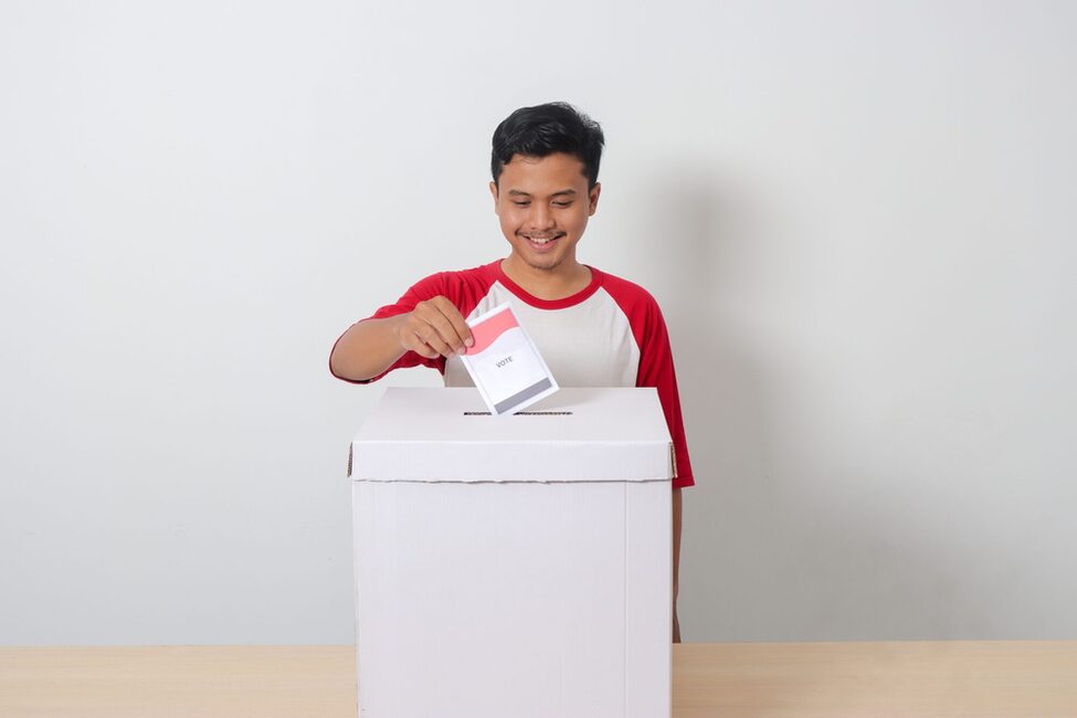 Portrait,Of,Excited,Asian,Man,Inserting,And,Putting,The,Voting