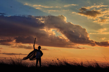 Silhouette,Of,Little,Boy,Hold,Toy,Sword,Playing,On,Sunset