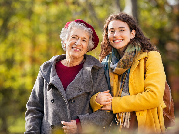 Portrait,Of,Senior,Woman,In,Park,Walking,With,Smiling,Granddaughter.