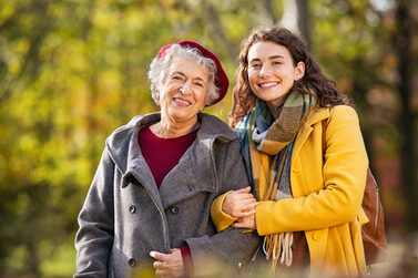 Portrait,Of,Senior,Woman,In,Park,Walking,With,Smiling,Granddaughter.