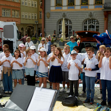 Eine Gruppe von Kindern steht zusammen und singt ein Lied