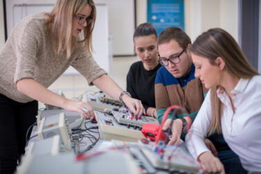 Vier Schüler, die im elektronischen Klassenzimmer üben